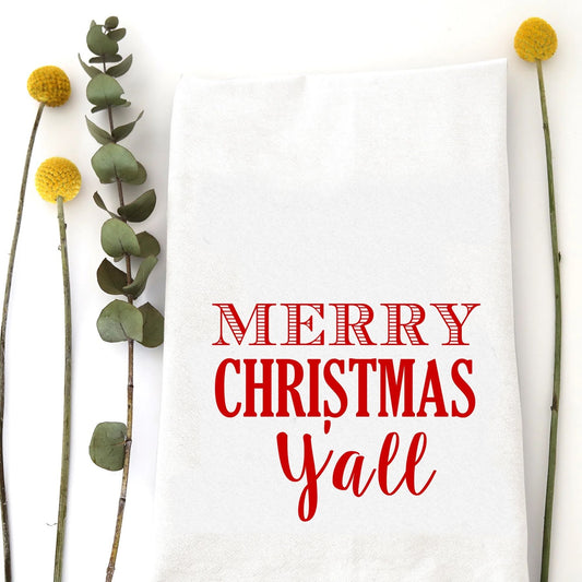 A holiday tea towel with the words "Merry Christmas Y'all" printed on it.