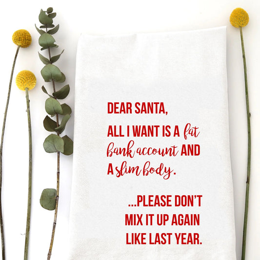 A holiday tea towel with  the words "Dear Santa, All I want is a fat bank account and a slim body. .. Please don't mix it up again like last year" printed on it.